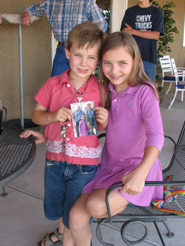 Steele and Taarna, Sophora's grandchildren, show off their photo of Uncle George